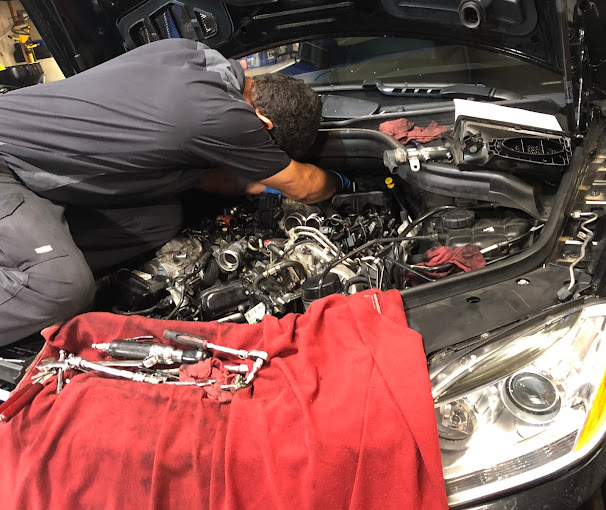 European mechanic servicing Audi vehicles